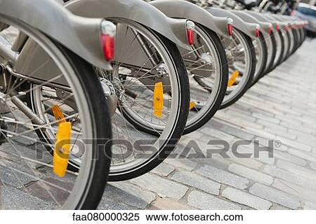 Bicycles parked in a row, cropped View Large Photo Image Stock Photography - Bicycles parked in a row, cropped. Fotosearch