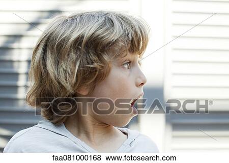 Stock Photo - Boy looking away with shocked expression. Fotosearch