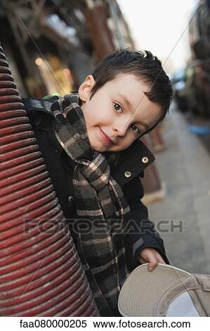 Boy peering around column at camera, portrait View Large Photo Image Stock Photography - Boy peering around column at camera, portrait. Fotosearch
