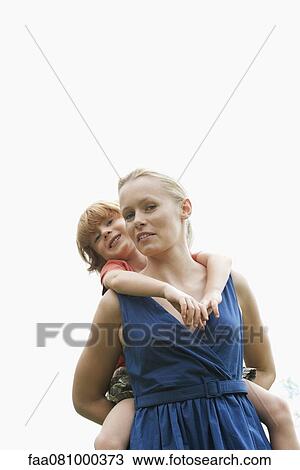 Stock Image - Boy riding on mother's back. Fotosearch