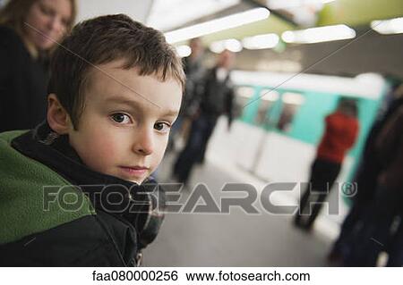 Stock Photograph - Boy waiting for train in subway station. Fotosearch