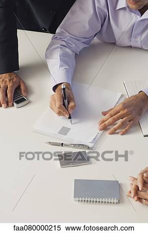 Business associates brainstorming together, cropped View Large Photo Image Stock Photography - Business associates brainstorming together, cropped. Fotosearch