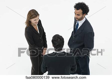 Stock Photo - Business associates chatting. Fotosearch
