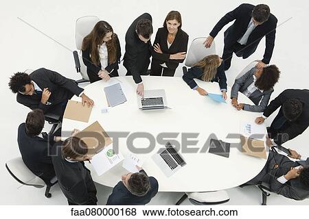 Stock Photo - Business associates working together in meeting. Fotosearch
