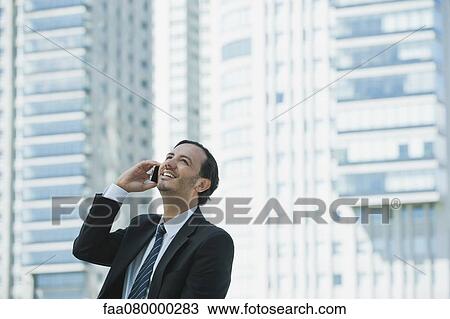 Business executive using cell phone outdoors View Large Photo Image Stock Image - Business executive using cell phone outdoors. Fotosearch