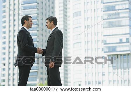 Stock Photo - Business executives shaking hands. Fotosearch