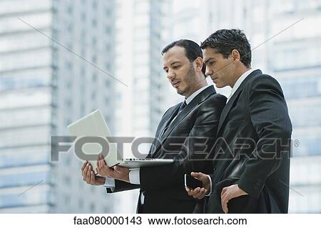 Business executives using laptop computer outdoors View Large Photo Image Stock Image - Business executives using laptop computer outdoors. Fotosearch