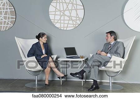 Picture - Businessman and businesswoman in meeting. Fotosearch