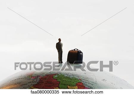 Businessman figurine with luggage standing on top of globe View Large Photo Image Stock Photography - Businessman figurine with luggage standing on top of globe. Fotosearch