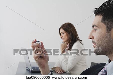 Businessman holding yin yang balls in office View Large Photo Image Stock Photography - Businessman holding yin yang balls in office. Fotosearch