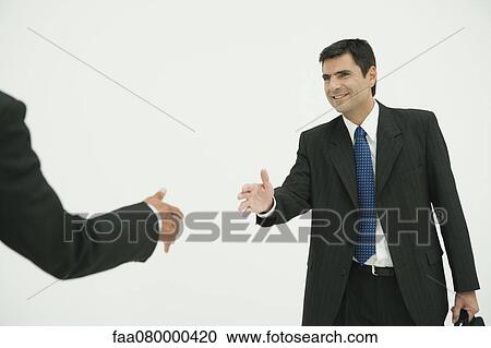 Businessman preparing to shake hands with colleague, cropped View Large Photo Image Stock Image - Businessman preparing to shake hands with colleague, cropped. Fotosearch