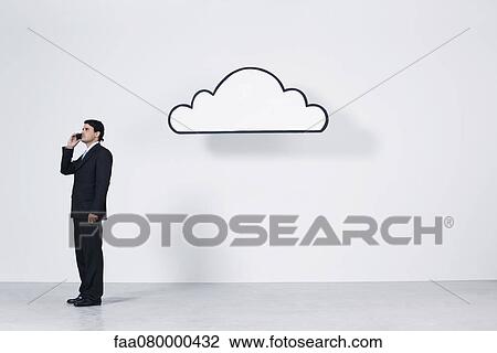 Businessman talking on cell phone near graphic cloud representing cloud computing View Large Photo Image Stock Image - Businessman talking on cell phone near graphic cloud representing cloud computing. Fotosearch