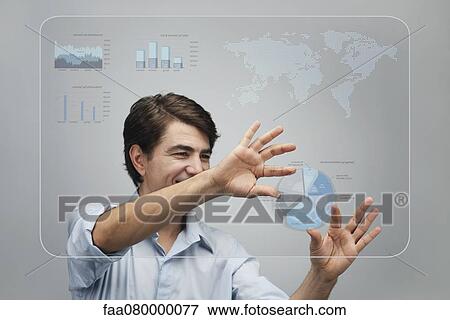 Stock Photo - Businessman using advanced touch screen technology to view sales data. Fotosearch