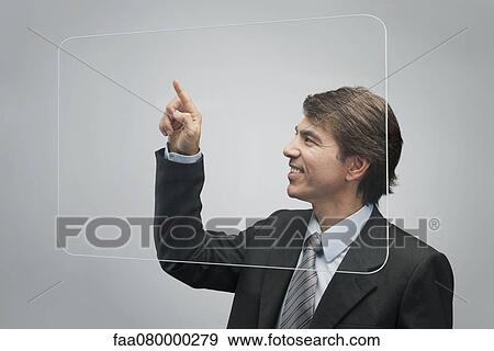 Businessman using large transparent touch screen View Large Photo Image Stock Photo - Businessman using large transparent touch screen. Fotosearch