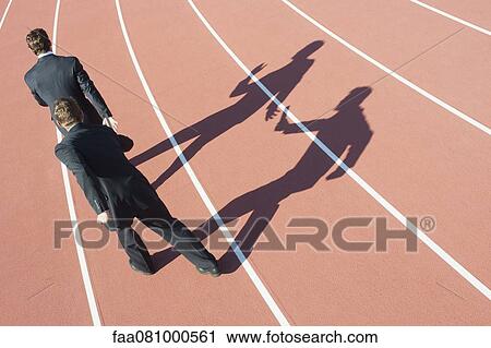 Businessmen passing baton, rear view View Large Photo Image Stock Image - Businessmen passing baton, rear view. Fotosearch