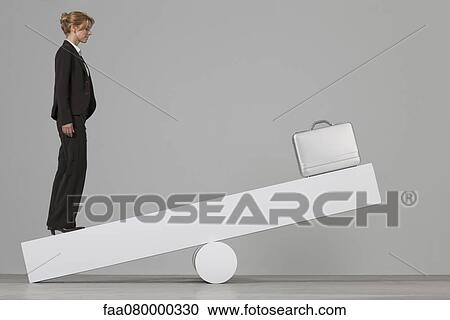 Businesswoman balancing on seesaw View Large Photo Image Stock Image - Businesswoman balancing on seesaw. Fotosearch