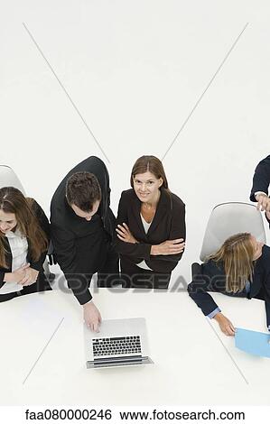Businesswoman collaborating with colleague in meeting View Large Photo Image Stock Photograph - Businesswoman collaborating with colleague in meeting. Fotosearch