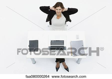 Businesswoman relaxing at desk with eyes closed View Large Photo Image Picture - Businesswoman relaxing at desk with eyes closed. Fotosearch