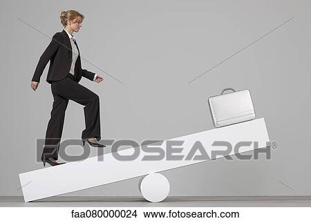 Businesswoman running toward briefcase on seesaw View Large Photo Image Picture - Businesswoman running toward briefcase on seesaw. Fotosearch