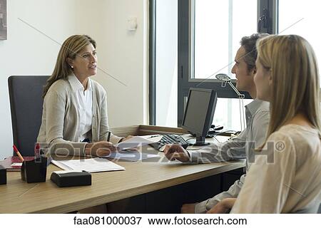 Businesswoman talking with clients in office View Large Photo Image Stock Photo - Businesswoman talking with clients in office. Fotosearch