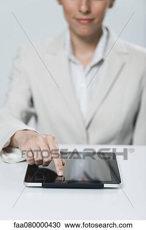 Businesswoman using touch screen on digital tablet View Large Photo Image Stock Image - Businesswoman using touch screen on digital tablet. Fotosearch