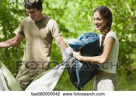 Campers putting away sleeping bag and tent View Large Photo Image Stock Image - Campers putting away sleeping bag and tent. Fotosearch