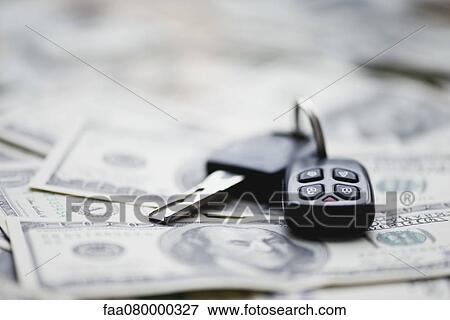 Car key on pile of one hundred dollar bills View Large Photo Image Stock Photo - Car key on pile of one hundred dollar bills. Fotosearch