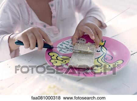 Stock Photo - Child preparing snack, cropped. Fotosearch