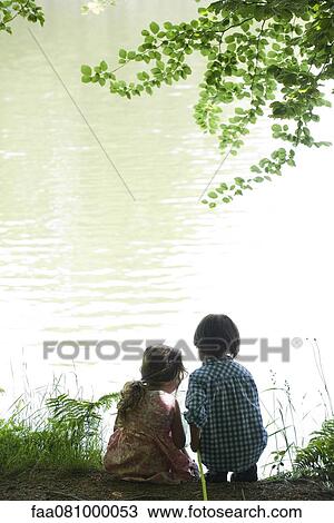 Children by lake with fish net, rear view, backlit View Large Photo Image Stock Image - Children by lake with fish net, rear view, backlit. Fotosearch