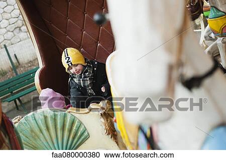 Children riding on carousel View Large Photo Image Stock Image - Children riding on carousel. Fotosearch