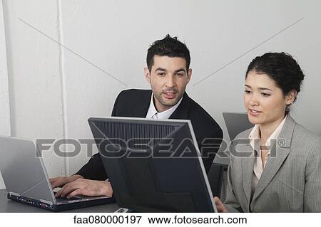 Colleagues discussing work View Large Photo Image Stock Photo - Colleagues discussing work. Fotosearch