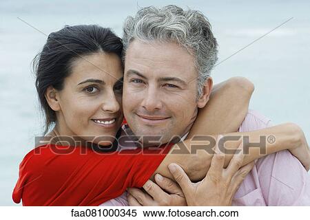 Stock Photography - Couple embracing, portrait. Fotosearch