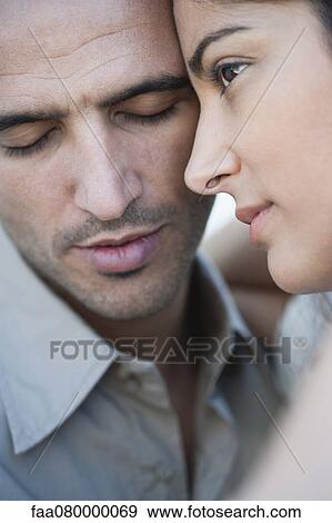 Stock Photo - Couple embracing with cheeks touching, cropped. Fotosearch