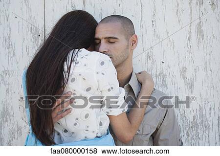 Stock Photo - Couple embracing with eyes closed. Fotosearch