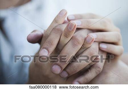 Couple holding hands, cropped View Large Photo Image Stock Photo - Couple holding hands, cropped. Fotosearch