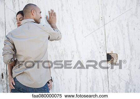 Couple leaning against wall embracing, off center View Large Photo Image Stock Photography - Couple leaning against wall embracing, off center. Fotosearch