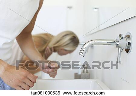 Couple together at bathroom sink, cropped View Large Photo Image Stock Photograph - Couple together at bathroom sink, cropped. Fotosearch