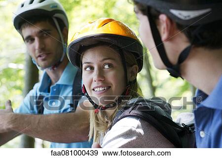 Cyclists hanging out together, focus on woman View Large Photo Image Stock Photo - Cyclists hanging out together, focus on woman. Fotosearch