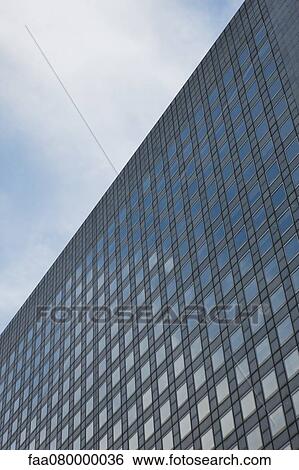 Stock Photograph - Facade of modern office building, low angle view. Fotosearch