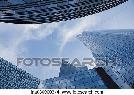 Facade of modern office buildings against sky, directly below View Large Photo Image Picture - Facade of modern office buildings against sky, directly below. Fotosearch