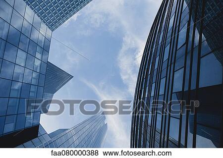 Facade of modern office buildings against sky, directly below View Large Photo Image Stock Photo - Facade of modern office buildings against sky, directly below. Fotosearch