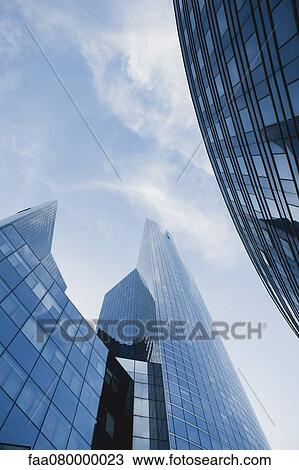 Facade of skyscrapers against sky, low angle view View Large Photo Image Stock Image - Facade of skyscrapers against sky, low angle view. Fotosearch