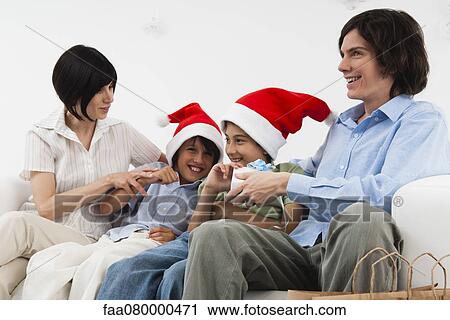 Family celebrating Christmas together View Large Photo Image Stock Image - Family celebrating Christmas together. Fotosearch