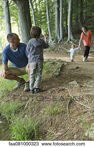 Stock Image - Family in woods. Fotosearch