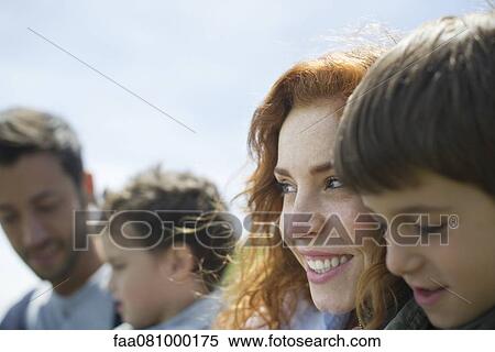 Stock Photography - Family together outdoors, focus on mother. Fotosearch