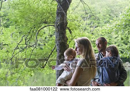 Stock Image - Family with two children in woods. Fotosearch