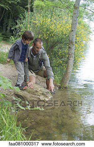 Stock Photo - Father and son by river. Fotosearch