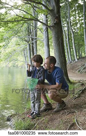 Father and son fishing, boy staring at tiny fish in hand View Large Photo Image Stock Photography - Father and son fishing, boy staring at tiny fish in hand. Fotosearch