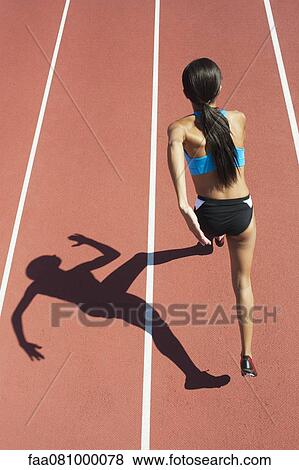 Female athlete running on track, focus on shadow View Large Photo Image Stock Photo - Female athlete running on track, focus on shadow. Fotosearch