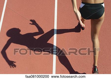 Female athlete running on track, low section, focus on shadow View Large Photo Image Stock Image - Female athlete running on track, low section, focus on shadow. Fotosearch